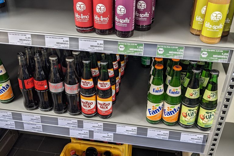 Nine in Ten Papers Disputing Ultra-Processed Food Definition Have Industry Ties, Study Finds Person reading food labels on packaged products in a supermarket